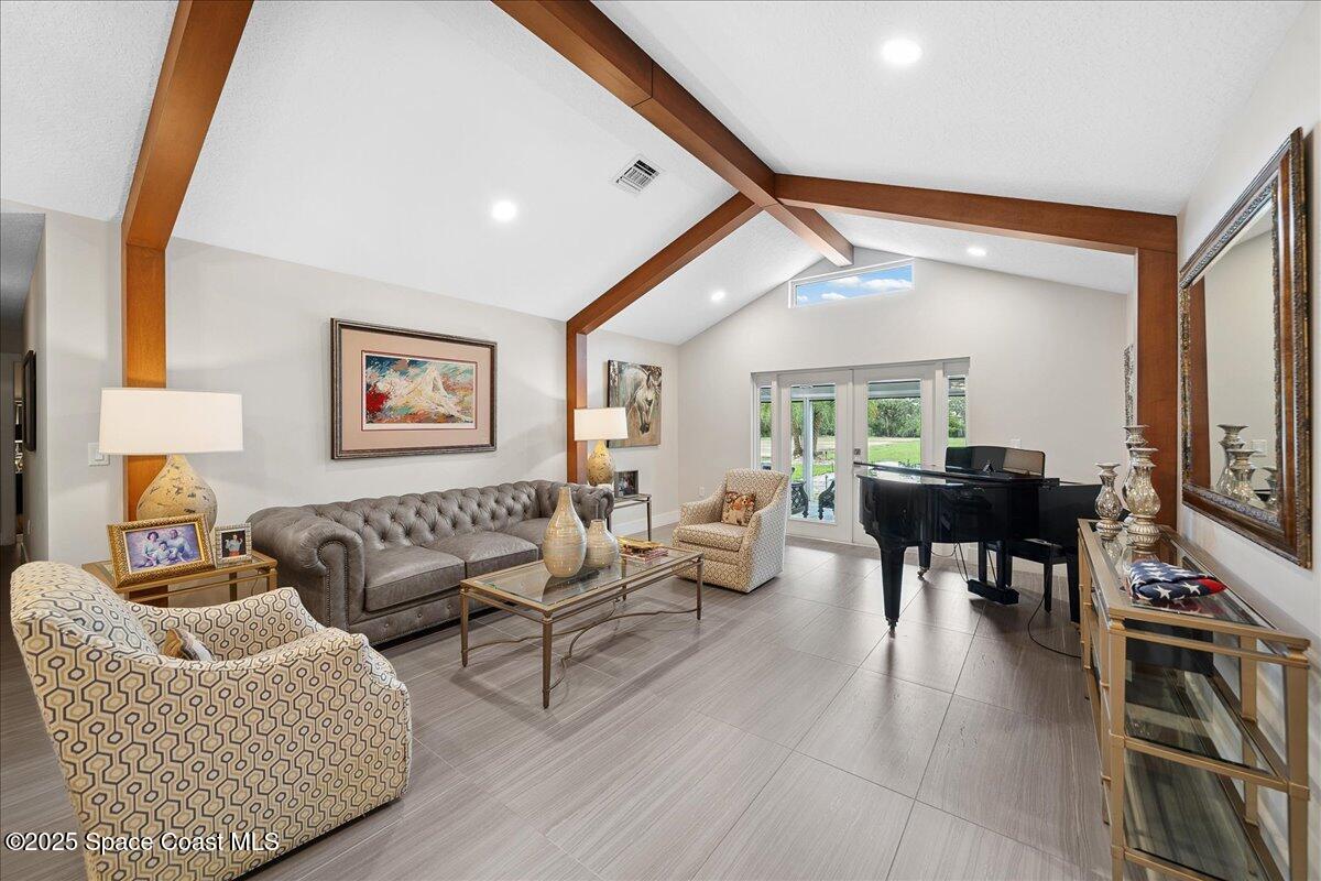 5685 Lake Washington Road Melbourne, FL 32934 - Photo 7 of 63 a living room with furniture and a flat screen tv
