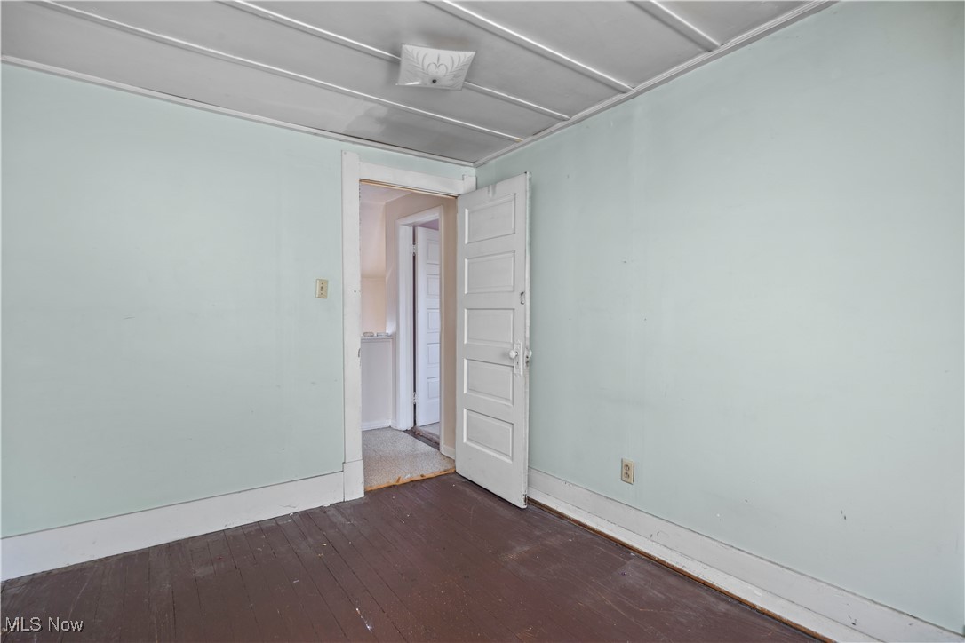6927 North Wildacre Road Curtice, OH 43412 - Photo 31 of 44 Empty room featuring wood-type flooring and baseboards