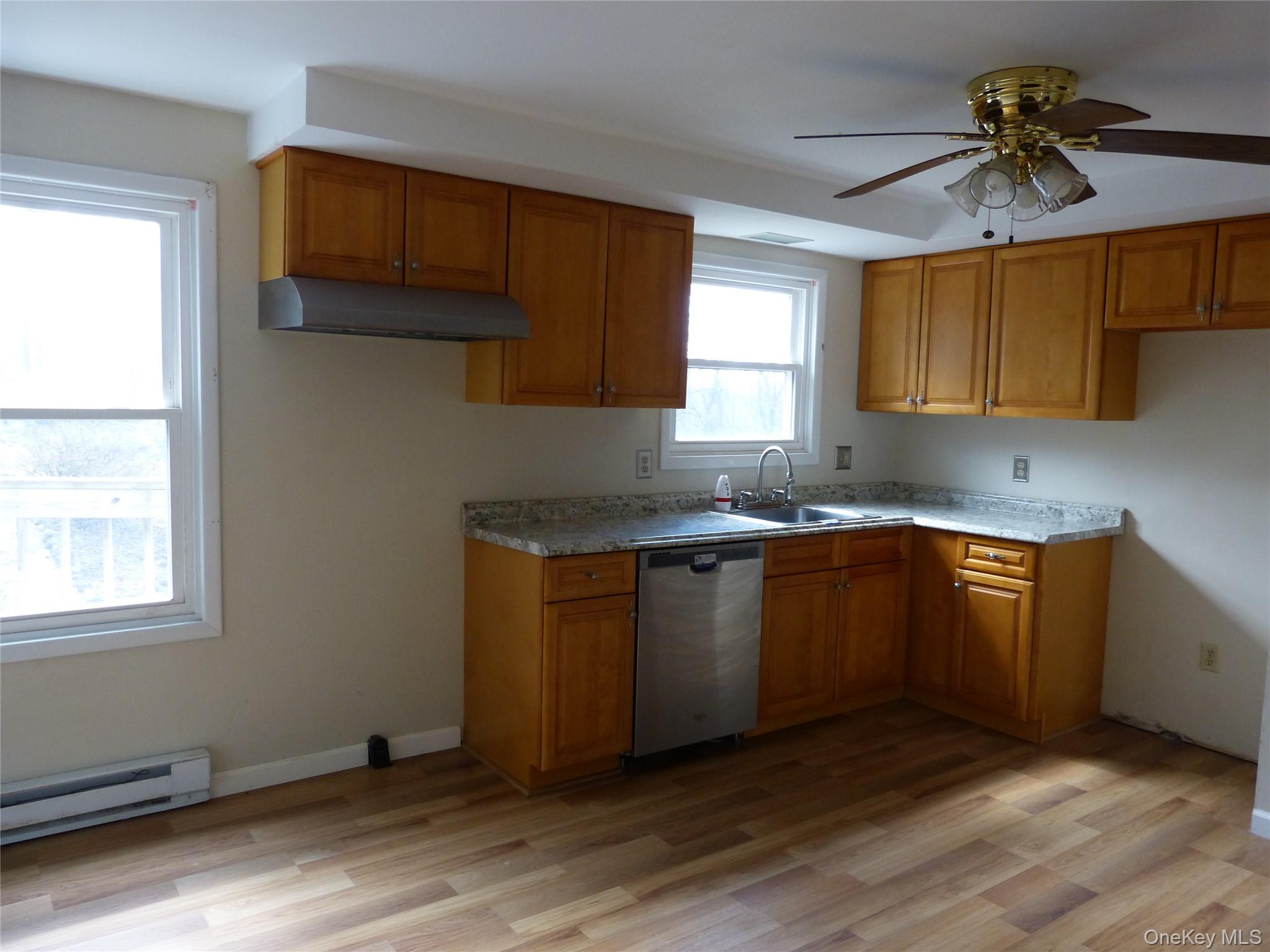 25 Liberty Corners Road Pine Island, NY 10969 - Photo 4 of 14 a kitchen with granite countertop wooden cabinets a sink a window and appliances