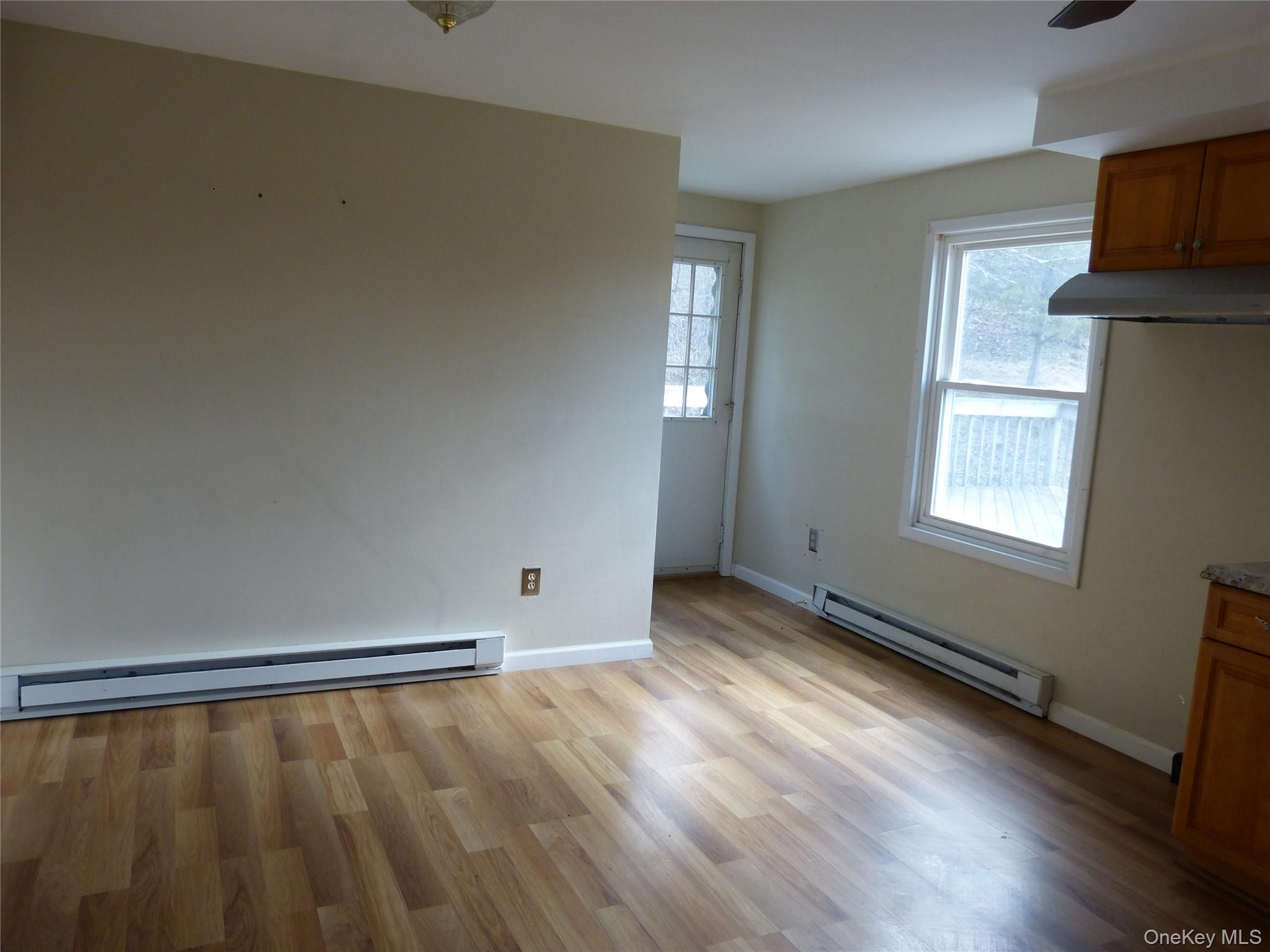 25 Liberty Corners Road Pine Island, NY 10969 - Photo 5 of 14 a view of an empty room with wooden floor and a window