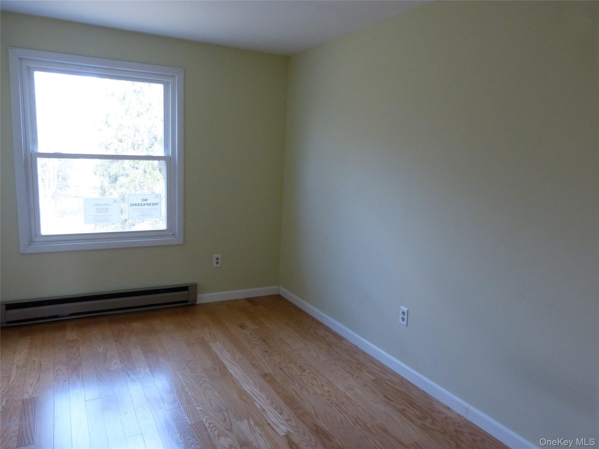25 Liberty Corners Road Pine Island, NY 10969 - Photo 7 of 14 an empty room with wooden floor and windows