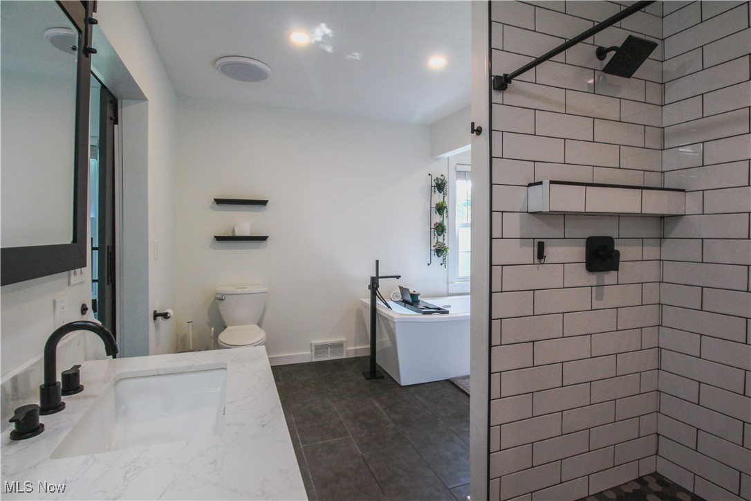 207 Harmon Road Aurora, OH 44202 - Photo 20 of 40 Primary bathroom with vanity, separate shower and soaking tub.