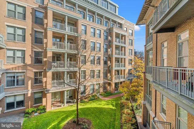 a view of a brick building next to a yard