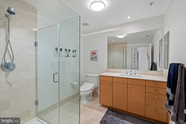 a bathroom with a double vanity sink toilet and shower