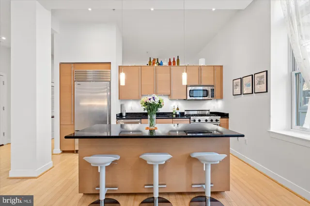 a dining table with chairs and cabinets