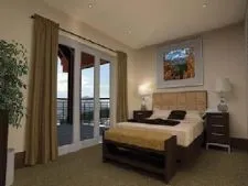 a spacious bedroom with a bed and a painting on the wall