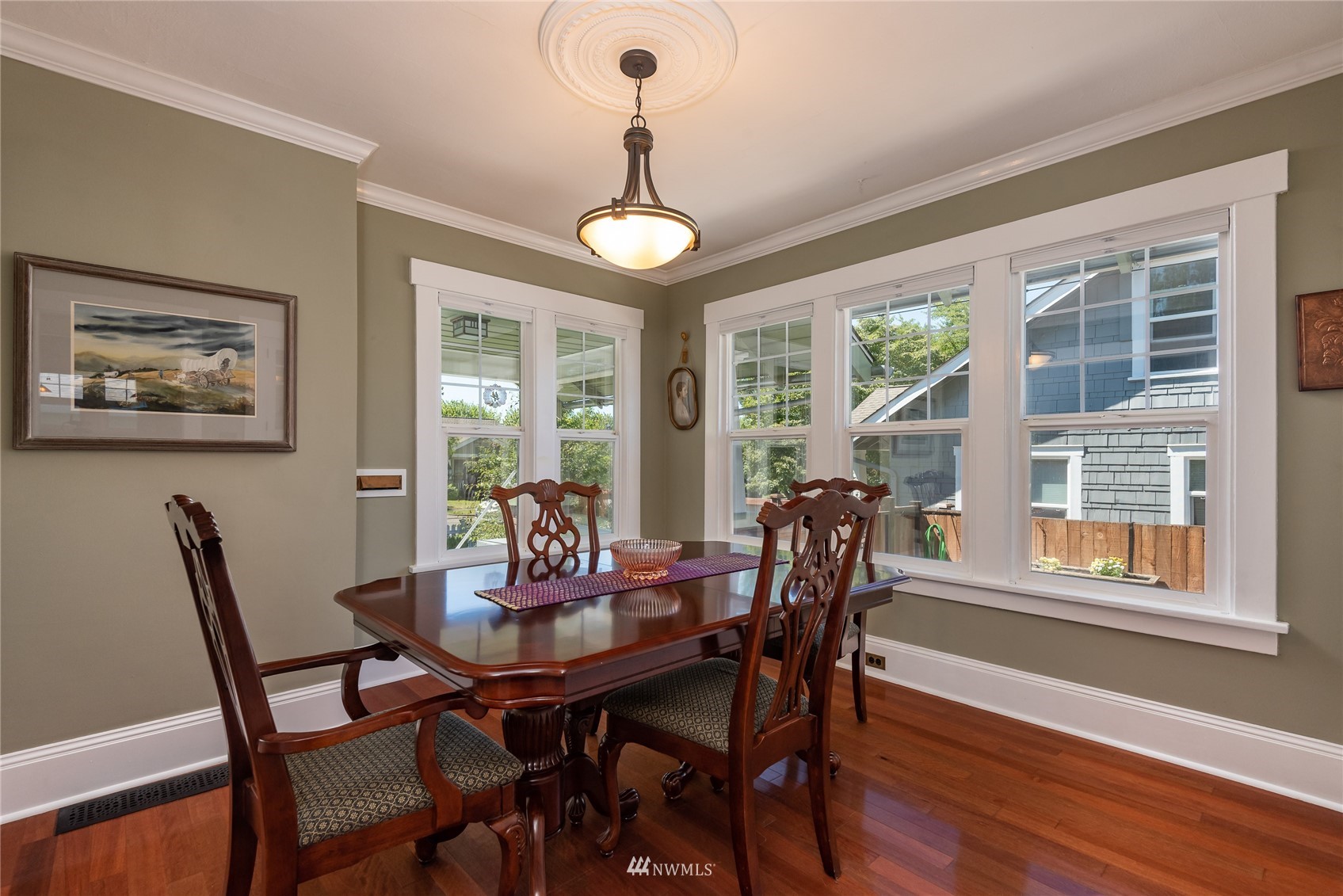 715 Sumner Avenue Sumner, WA 98390 - Photo 12 of 39 a dining room with furniture a chandelier and wooden floor