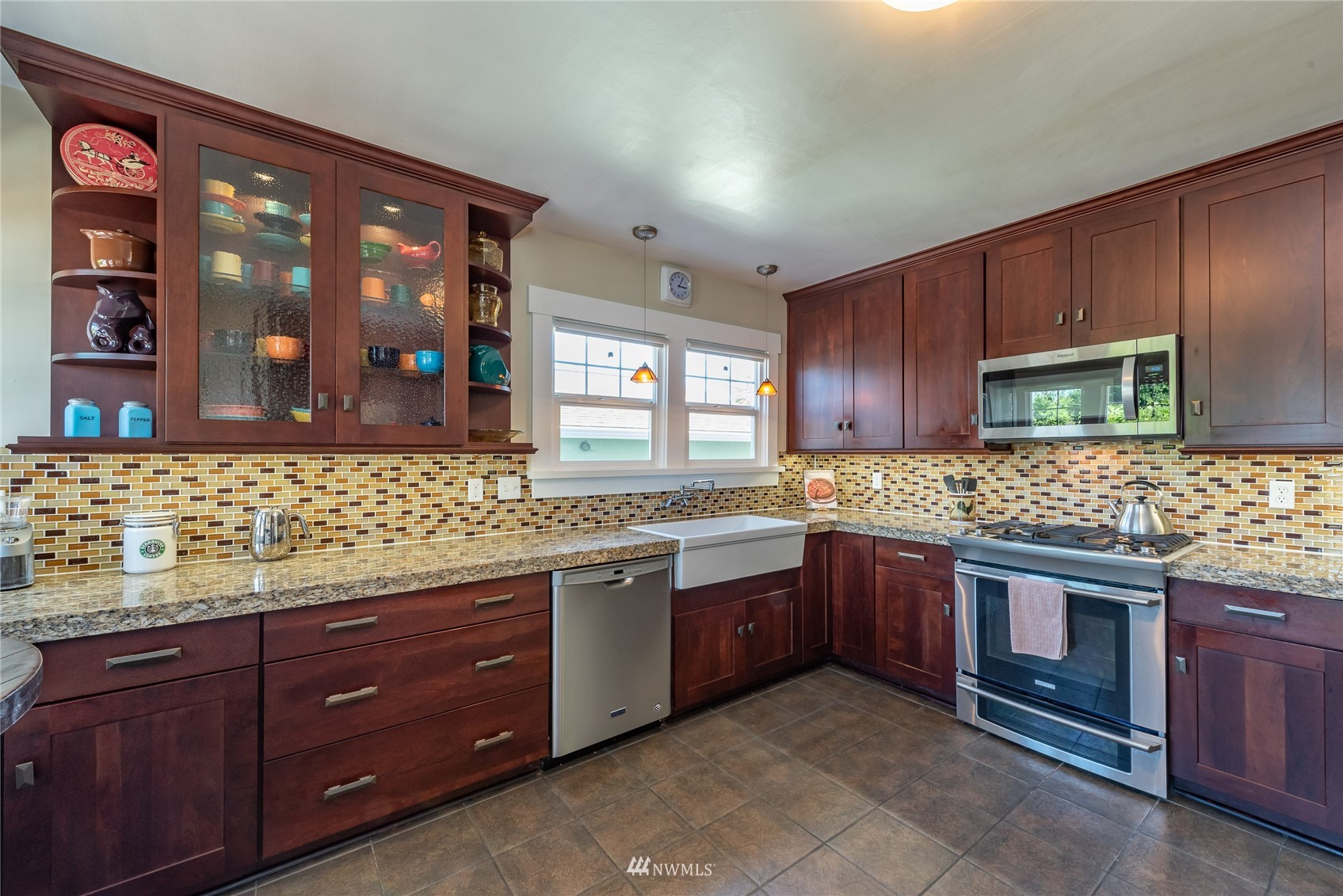 715 Sumner Avenue Sumner, WA 98390 - Photo 14 of 39 a kitchen with stainless steel appliances granite countertop wooden cabinets and a sink
