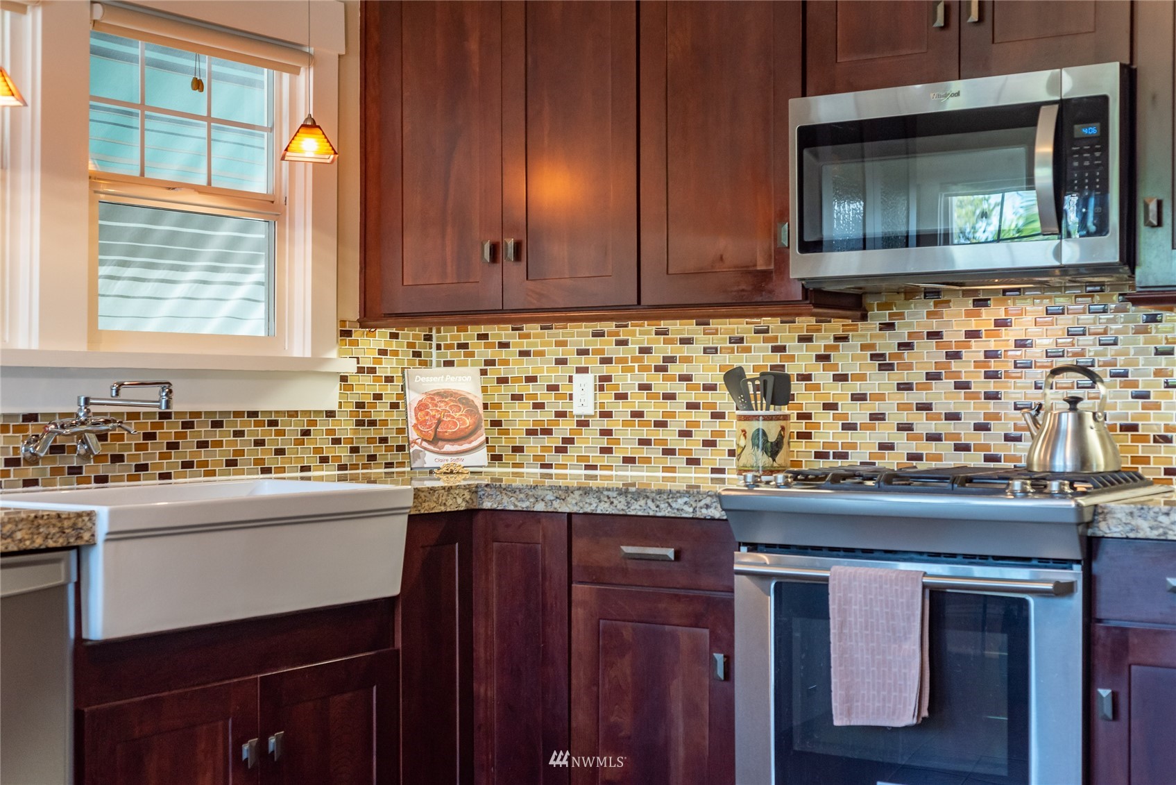 715 Sumner Avenue Sumner, WA 98390 - Photo 18 of 39 a kitchen with granite countertop cabinets sink and window