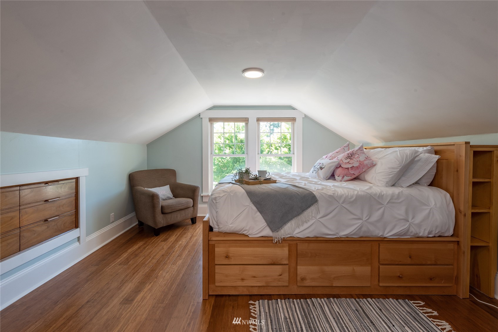 715 Sumner Avenue Sumner, WA 98390 - Photo 26 of 39 a bedroom with a bed and wooden floor
