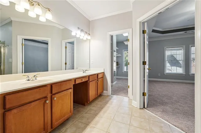 a spacious bathroom with a double vanity sink a large mirror and a shower