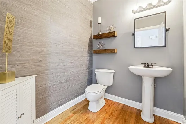 a bathroom with a sink toilet and a mirror