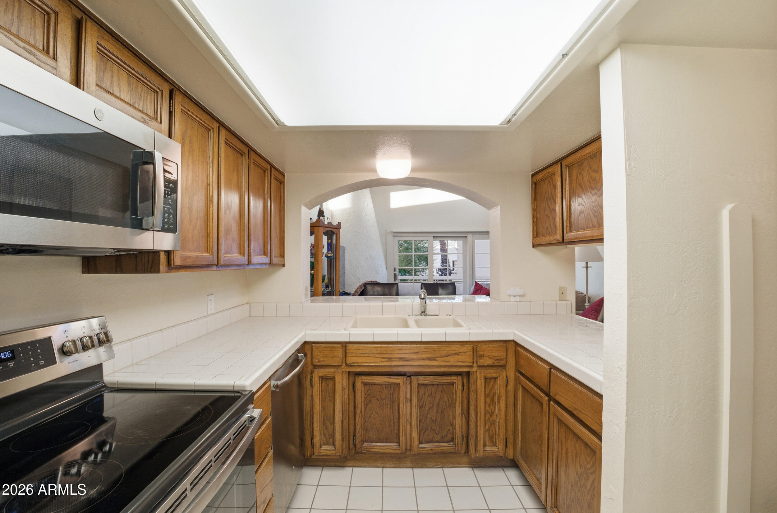 6150 North Scottsdale Road, Unit 52 Paradise Valley, AZ 85253 - Photo 11 of 24 a kitchen with a sink stove and cabinets