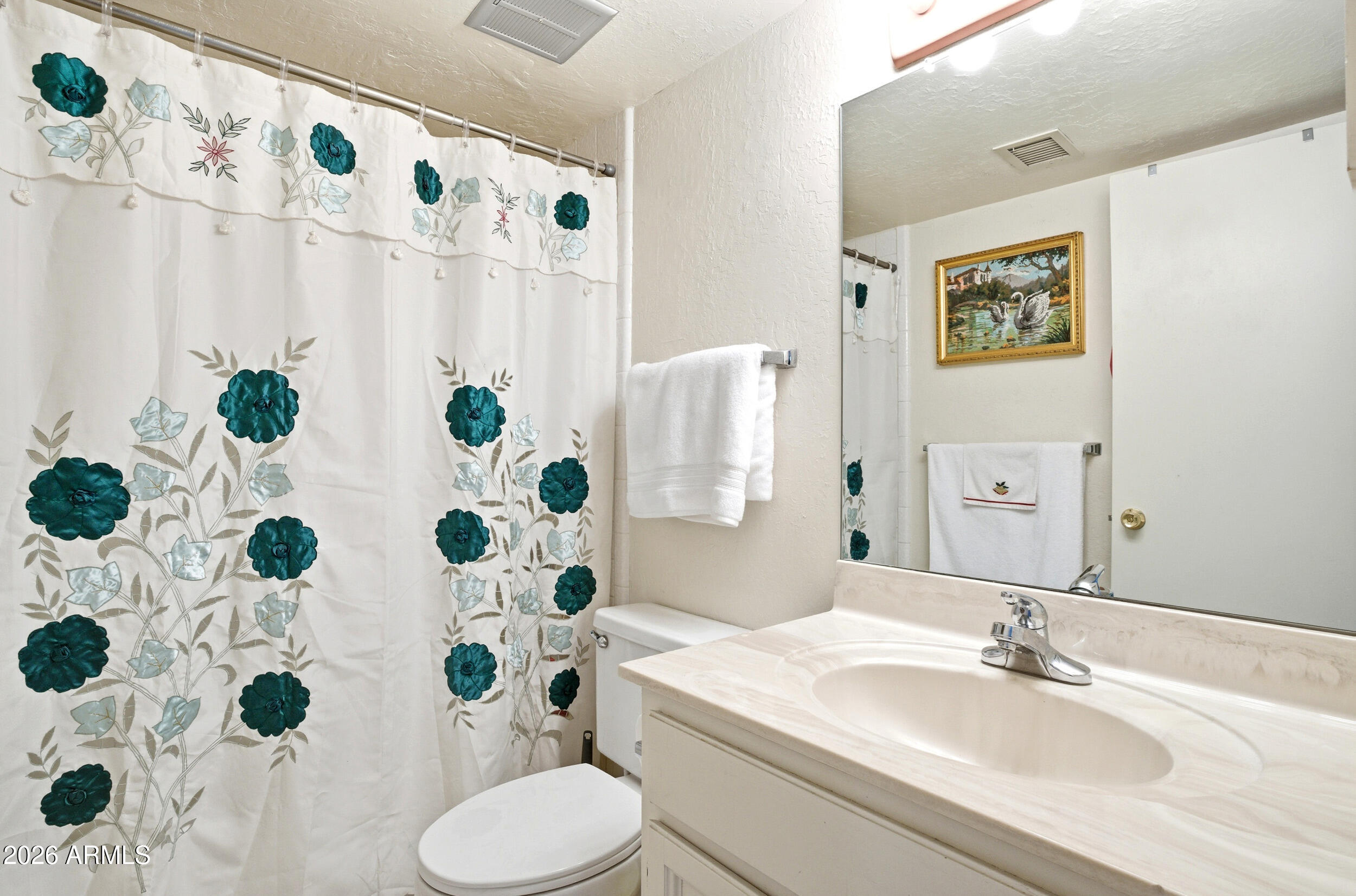 6150 North Scottsdale Road, Unit 52 Paradise Valley, AZ 85253 - Photo 15 of 24 a bathroom with a sink and mirror with shower curtain