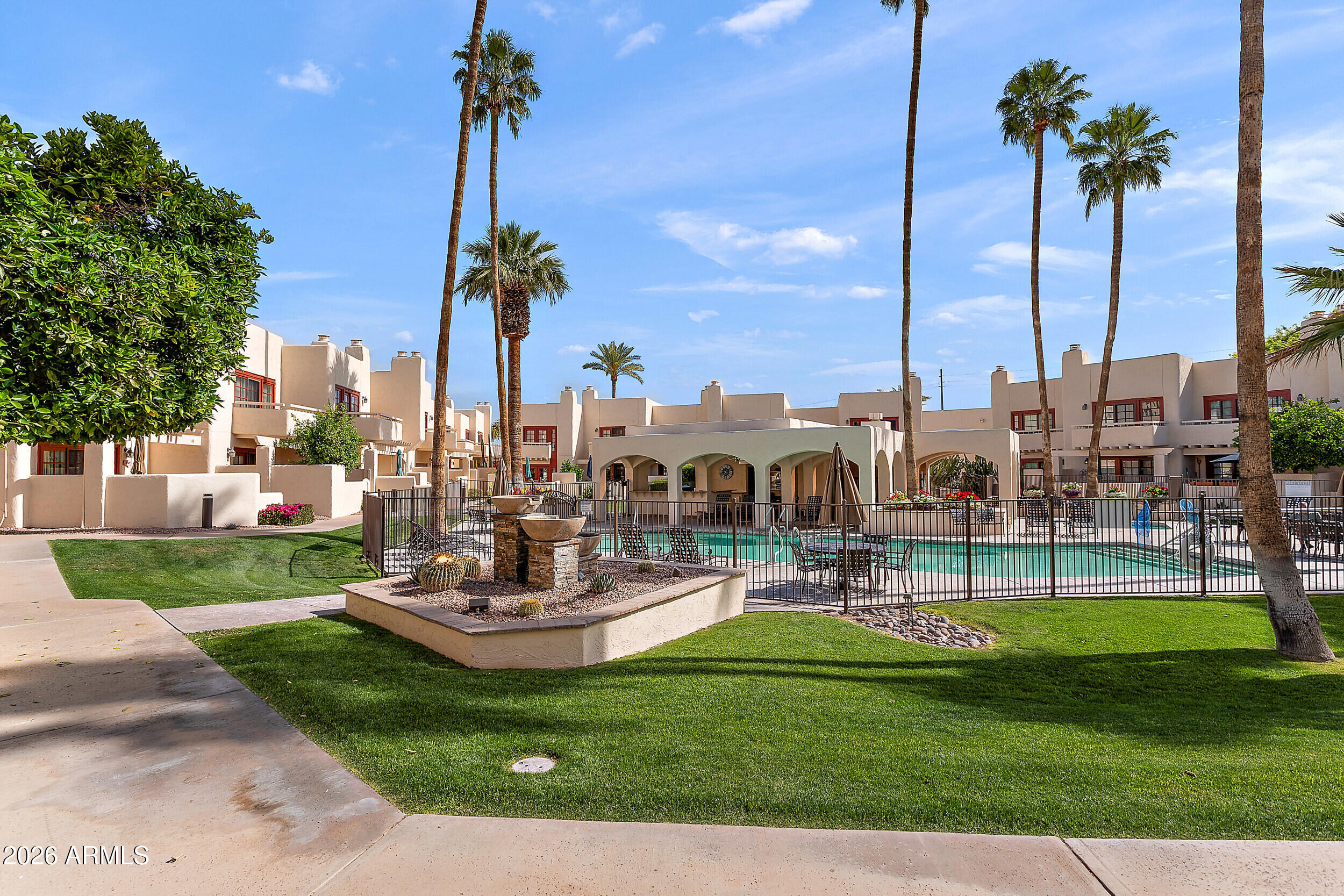 6150 North Scottsdale Road, Unit 52 Paradise Valley, AZ 85253 - Photo 2 of 24 a view of a park with couches and palm trees