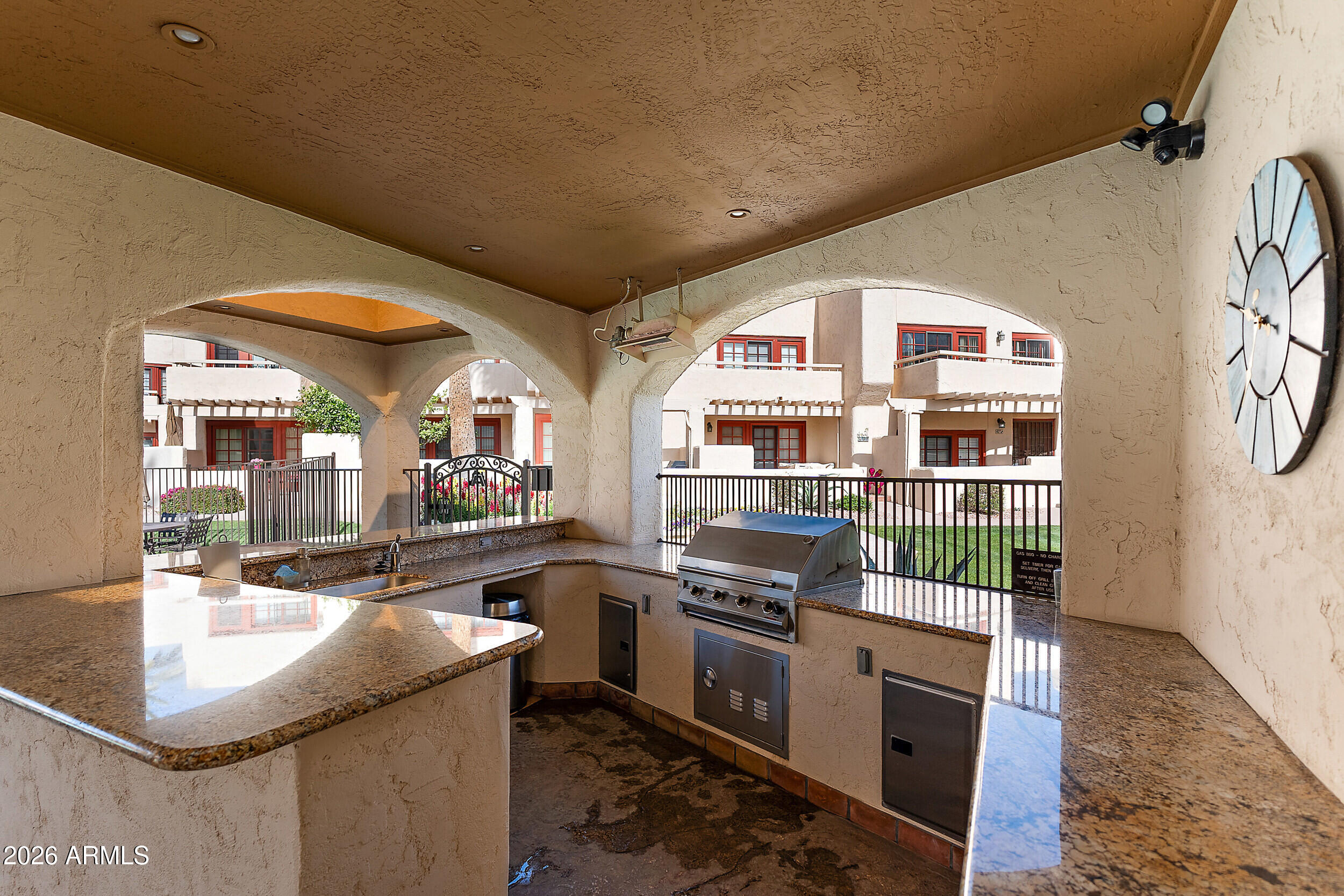 6150 North Scottsdale Road, Unit 52 Paradise Valley, AZ 85253 - Photo 21 of 24 a kitchen with stainless steel appliances granite countertop a sink and a stove