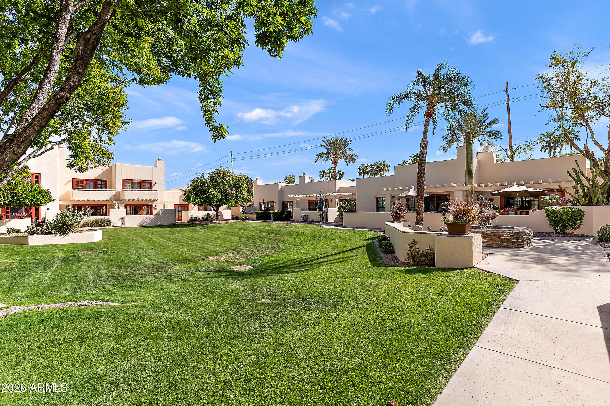 6150 North Scottsdale Road, Unit 52 Paradise Valley, AZ 85253 - Photo 23 of 24 a view of a house with a big yard and palm trees