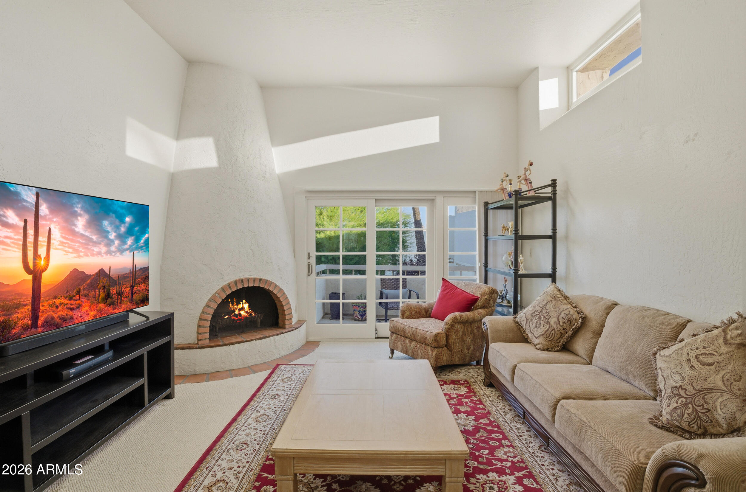 6150 North Scottsdale Road, Unit 52 Paradise Valley, AZ 85253 - Photo 3 of 24 a living room with furniture a flat screen tv and a floor to ceiling window