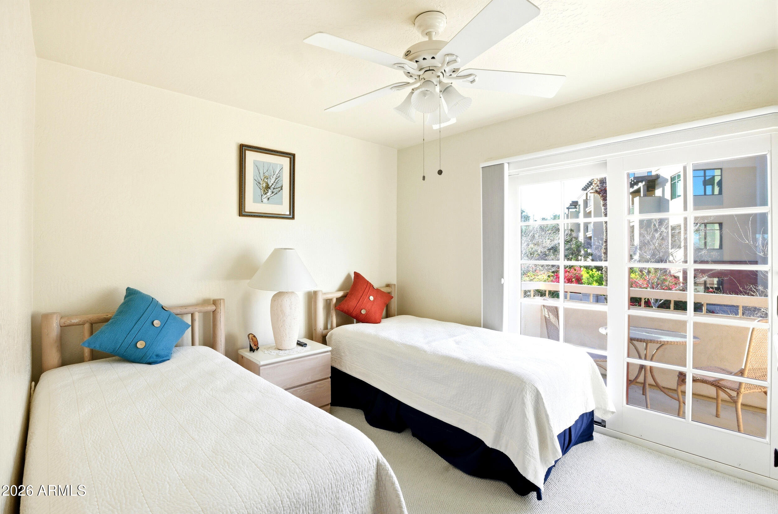 6150 North Scottsdale Road, Unit 52 Paradise Valley, AZ 85253 - Photo 6 of 24 a bedroom with two beds and a chandelier