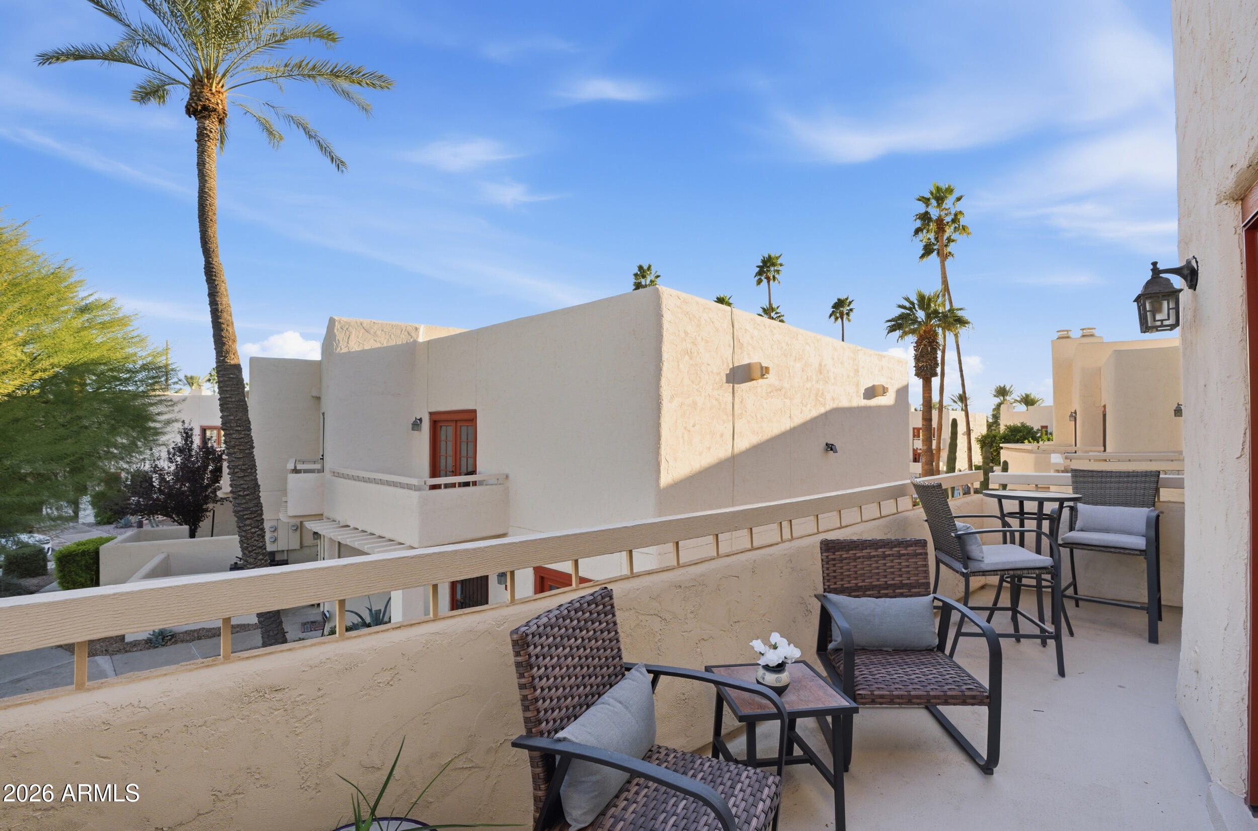 6150 North Scottsdale Road, Unit 52 Paradise Valley, AZ 85253 - Photo 7 of 24 a view of a chairs and table in a balcony