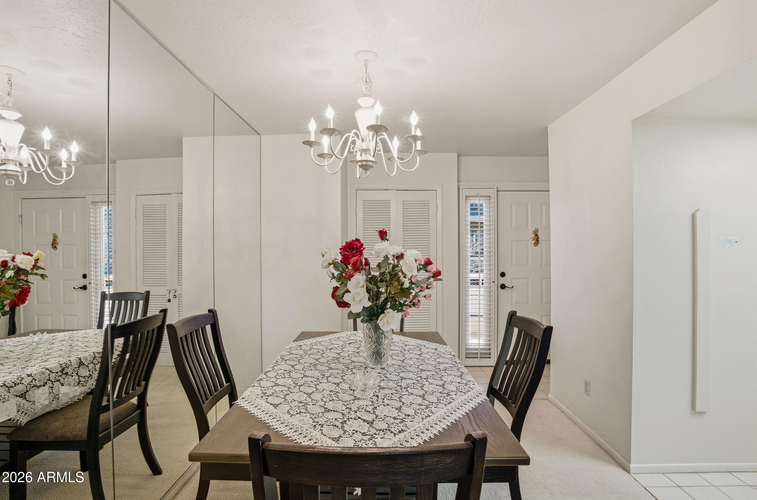 6150 North Scottsdale Road, Unit 52 Paradise Valley, AZ 85253 - Photo 9 of 24 a view of a dining room with furniture and chandelier