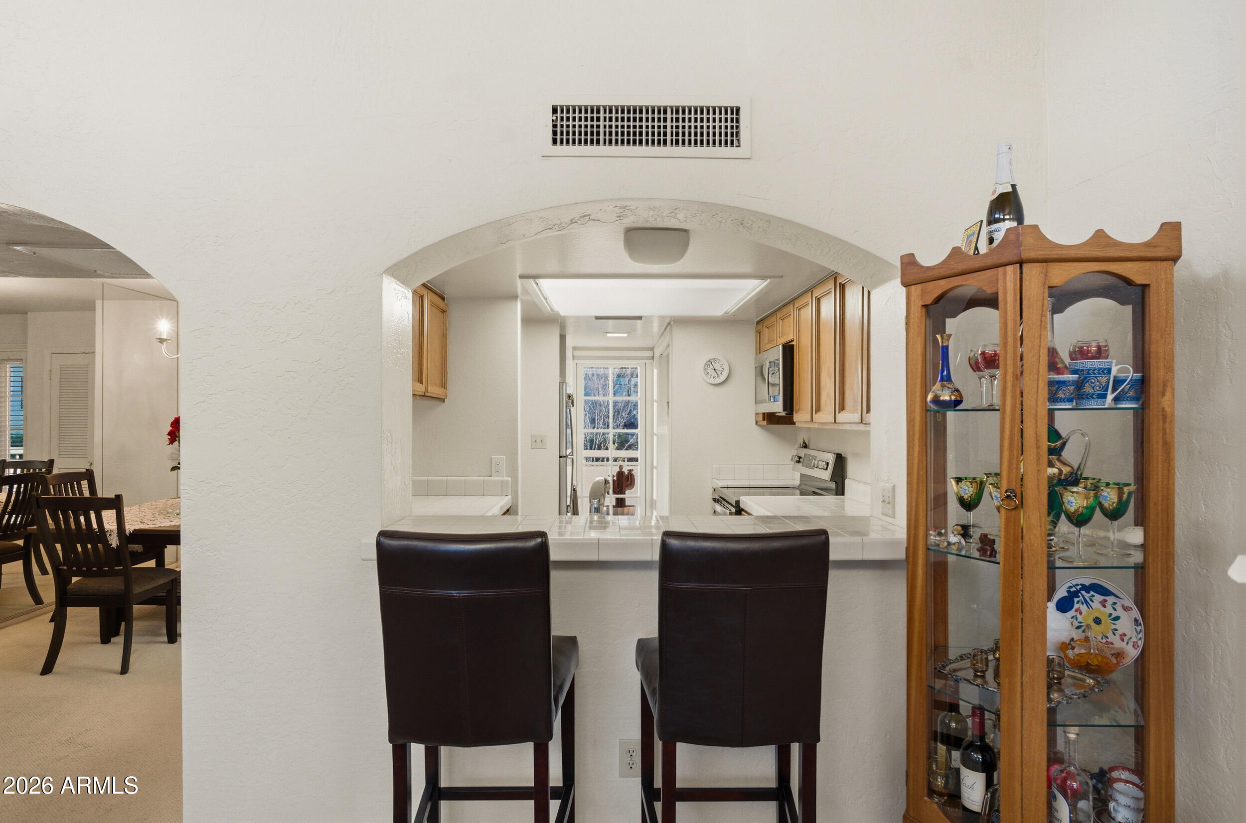 6150 North Scottsdale Road, Unit 52 Paradise Valley, AZ 85253 - Photo 10 of 24 a view of a dining room with furniture and a chandelier