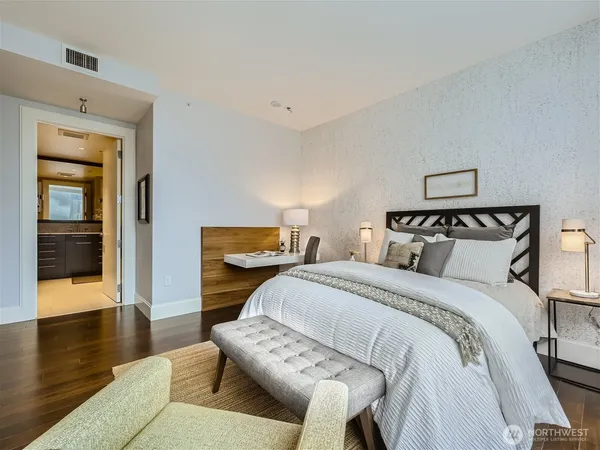 a bedroom with a bed and wooden floor