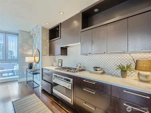 a kitchen with stainless steel appliances a sink a stove and cabinets