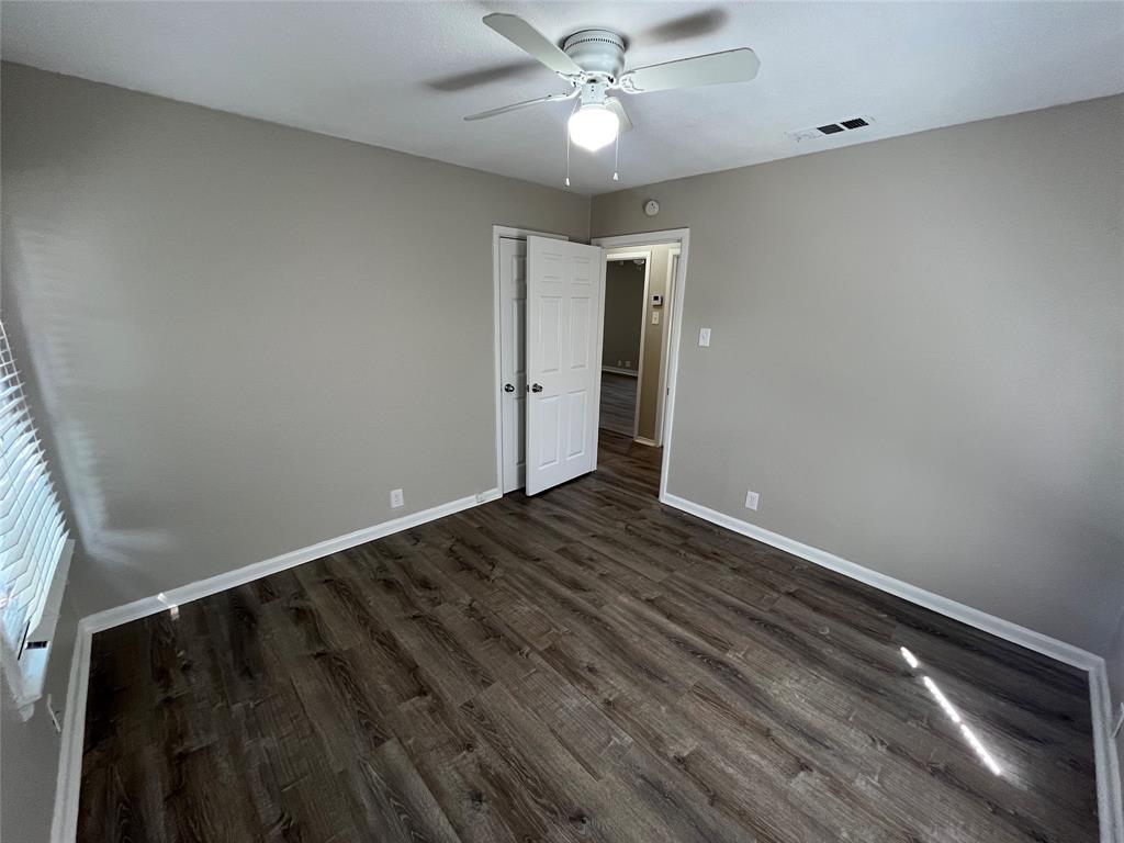 1622 Centerville Road Dallas, TX 75228 - Photo 18 of 19 Wood-finish flooring, light gray wall color, white ceiling fan, and window with horizontal blinds