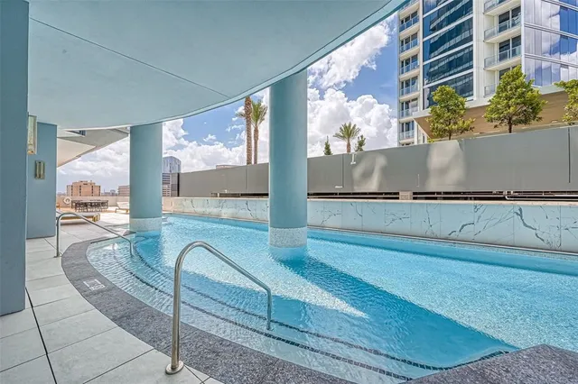 a view of a patio with swimming pool table and chairs