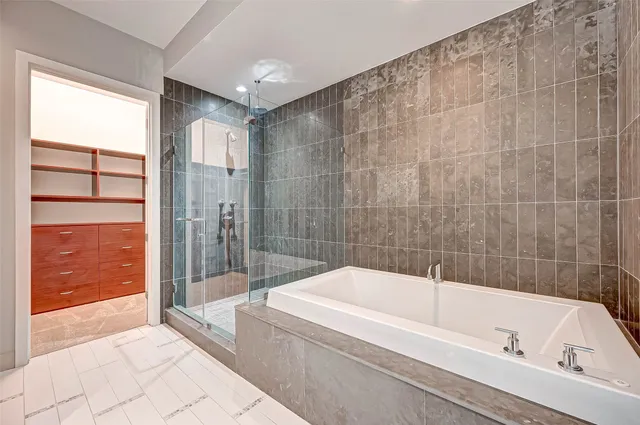 a bathroom with a tub a sink and a shower