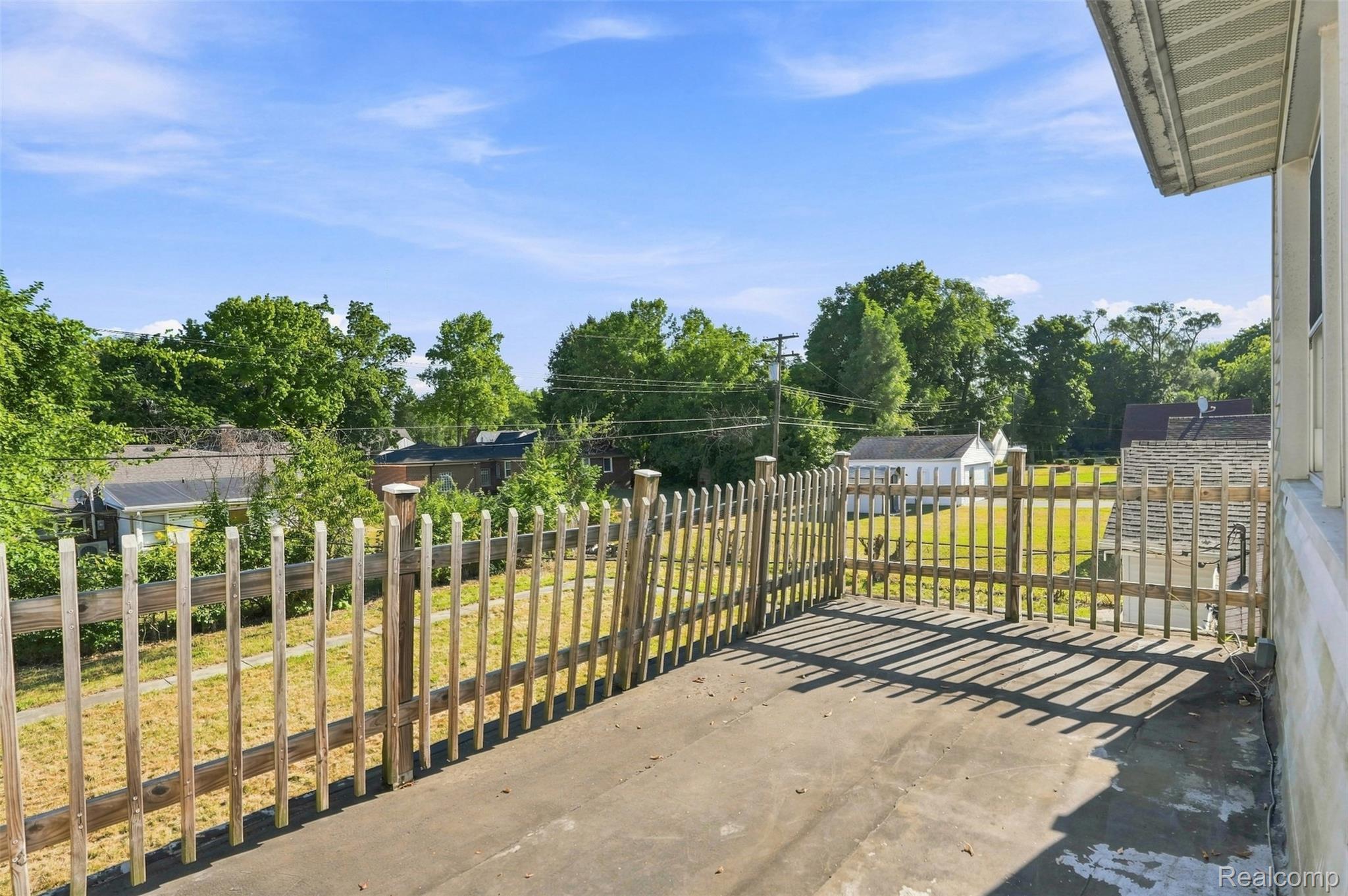 17620 Cornell Road Southfield, MI 48075 - Photo 22 of 29 Paved outdoor patio area with a wooden picket fence
