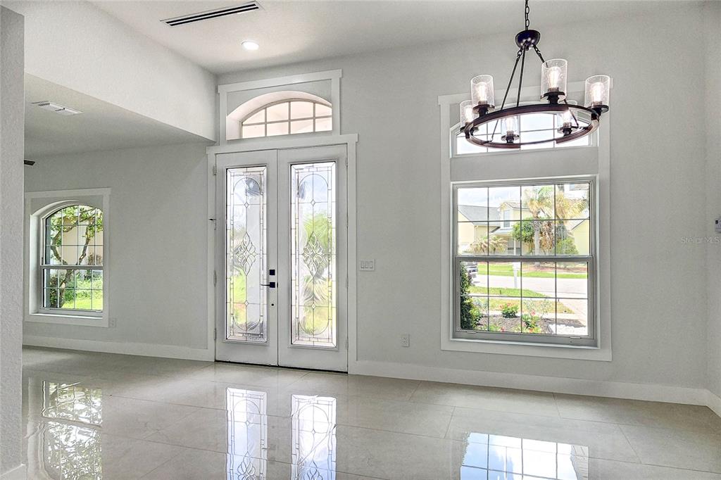 7027 Frascati Loop Wesley Chapel, FL 33544 - Photo 5 of 28 a view of an entryway with a chandelier