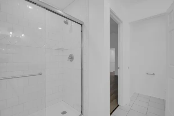 a bathroom with a shower and a sink