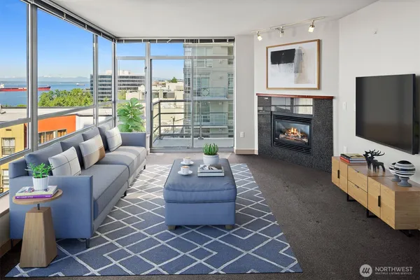 a living room with furniture a flat screen tv and a fireplace