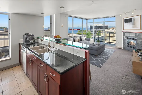 a kitchen with stainless steel appliances granite countertop a sink stove and cabinets