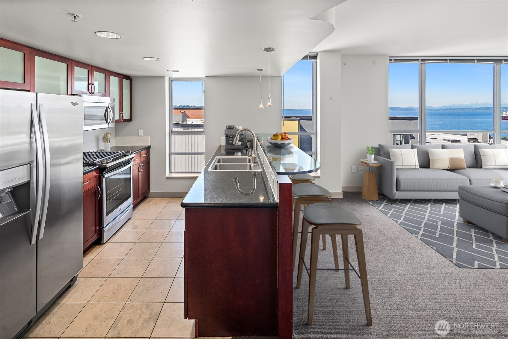 2929 1st Avenue, Unit 514 Seattle, WA 98121 - Photo 6 of 23 a kitchen with stainless steel appliances granite countertop a refrigerator a stove and a sink