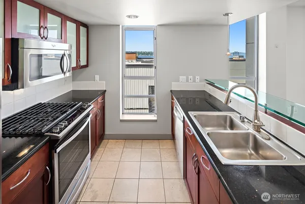 a kitchen that has a sink and a stove