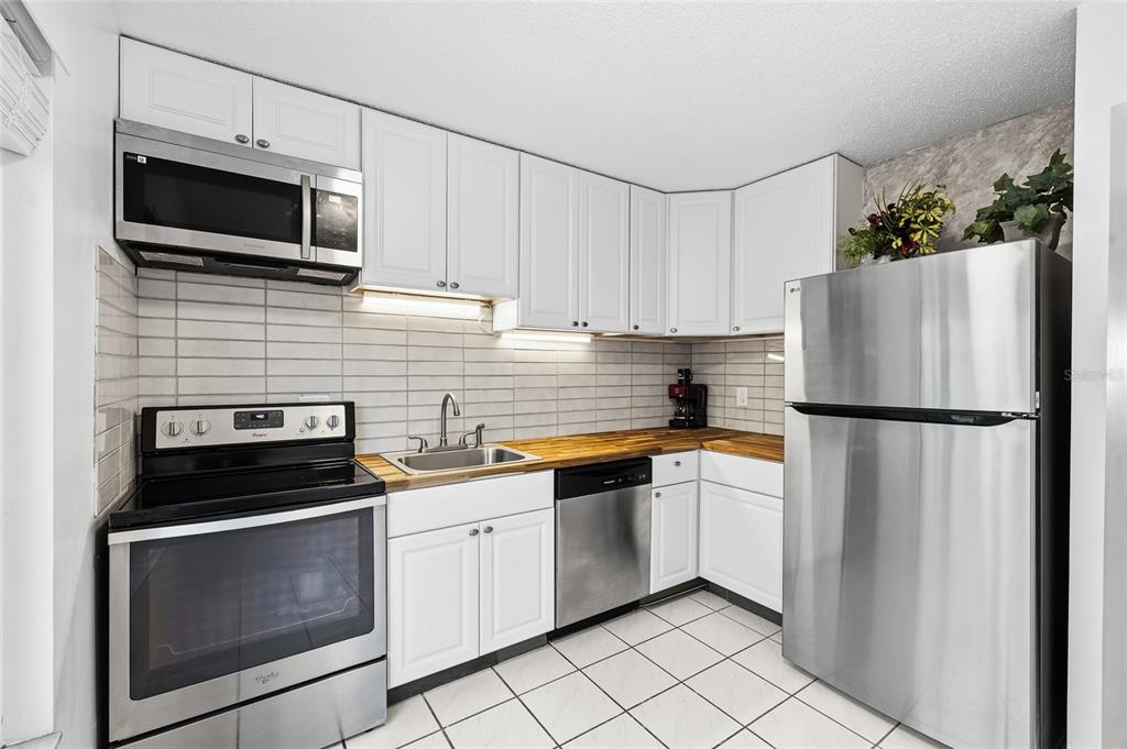 2209 Belleair Road, Unit C5 Clearwater, FL 33764 - Photo 11 of 30 a kitchen with a refrigerator stove and microwave
