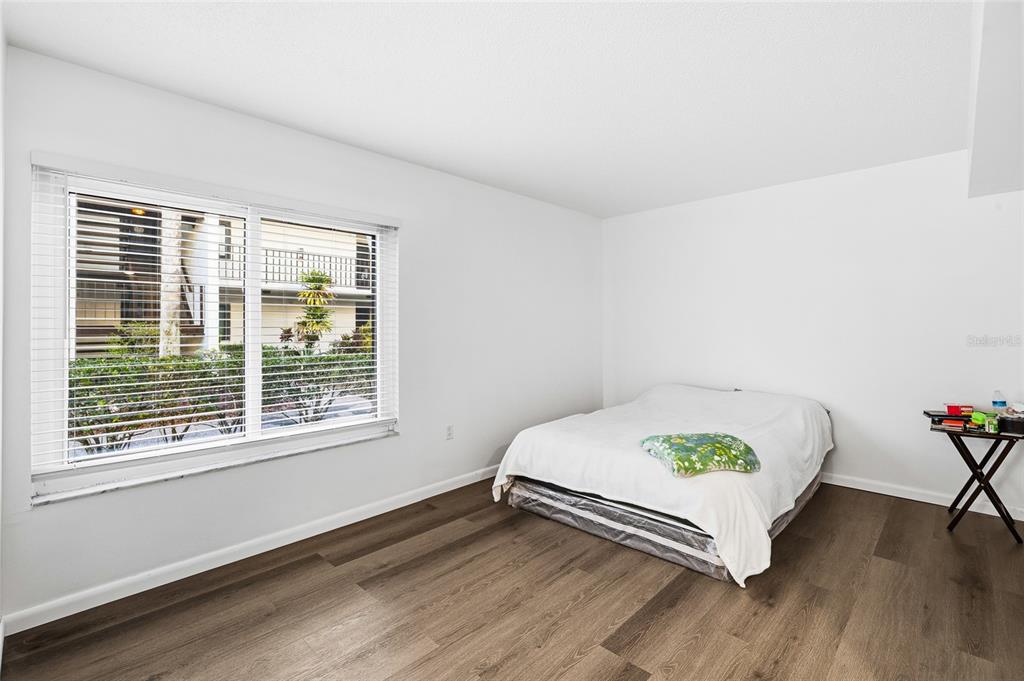 2209 Belleair Road, Unit C5 Clearwater, FL 33764 - Photo 13 of 30 a bed sitting in a bedroom next to a window