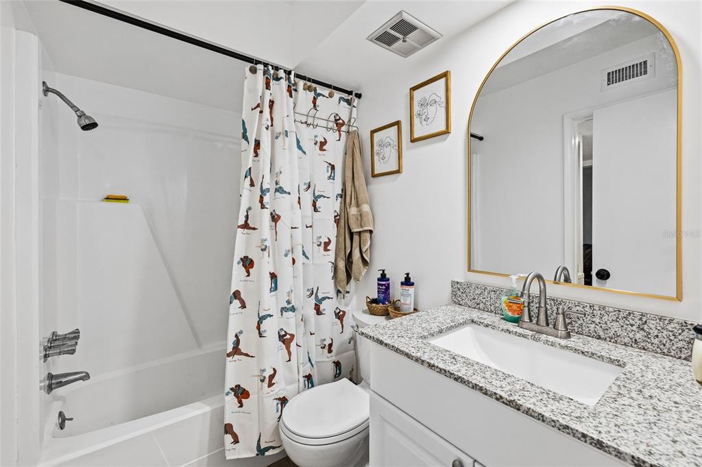 2209 Belleair Road, Unit C5 Clearwater, FL 33764 - Photo 18 of 30 a bathroom with a granite countertop sink a toilet and shower