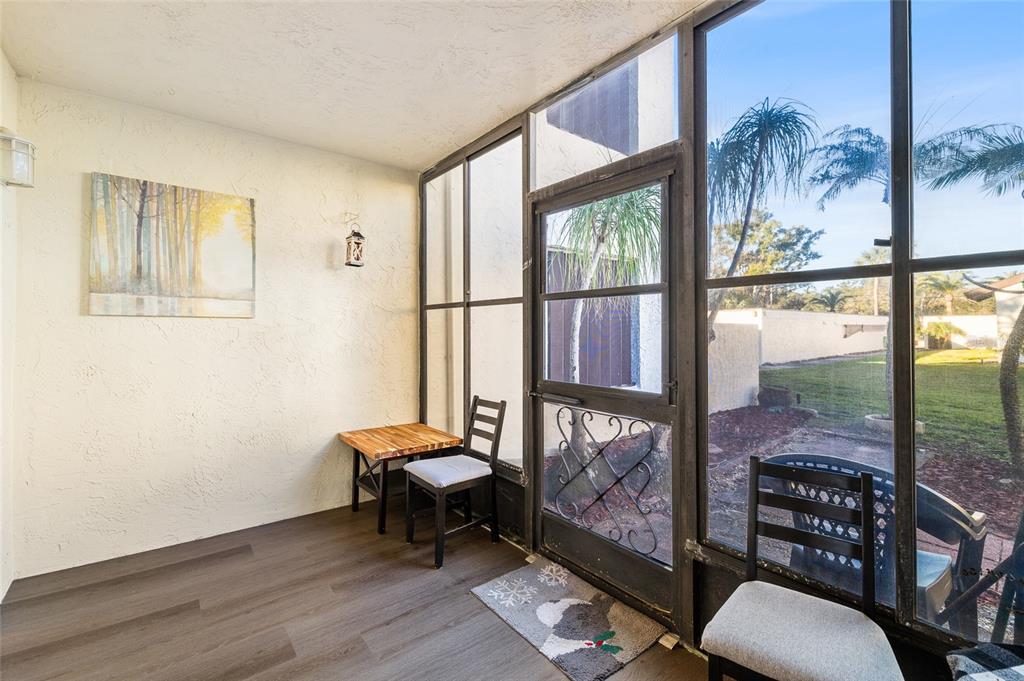 2209 Belleair Road, Unit C5 Clearwater, FL 33764 - Photo 21 of 30 a living room with furniture and a floor to ceiling window