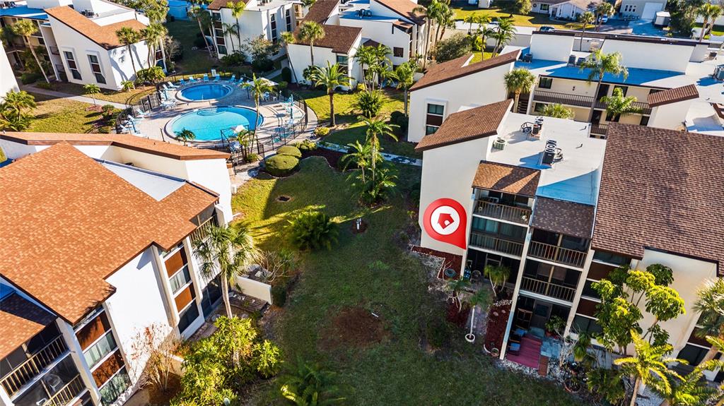 2209 Belleair Road, Unit C5 Clearwater, FL 33764 - Photo 27 of 30 an aerial view of multiple houses with yard