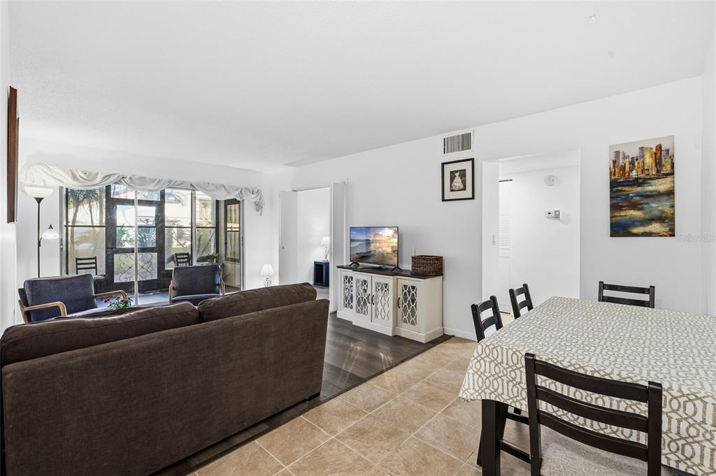 2209 Belleair Road, Unit C5 Clearwater, FL 33764 - Photo 5 of 30 a living room with furniture a flat screen tv and a window