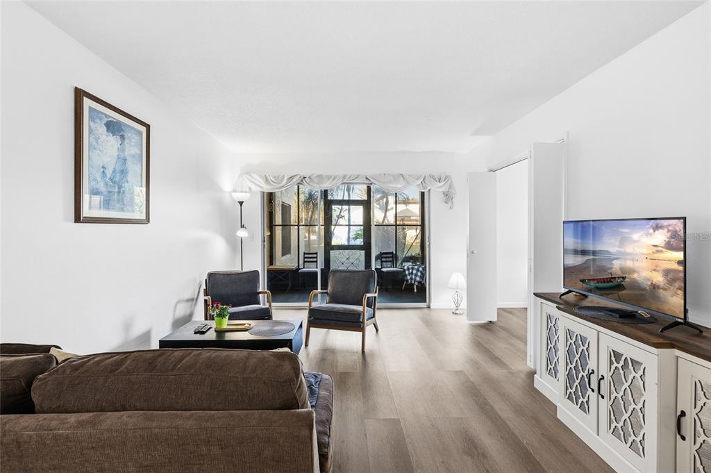 2209 Belleair Road, Unit C5 Clearwater, FL 33764 - Photo 6 of 30 a living room with furniture and a flat screen tv