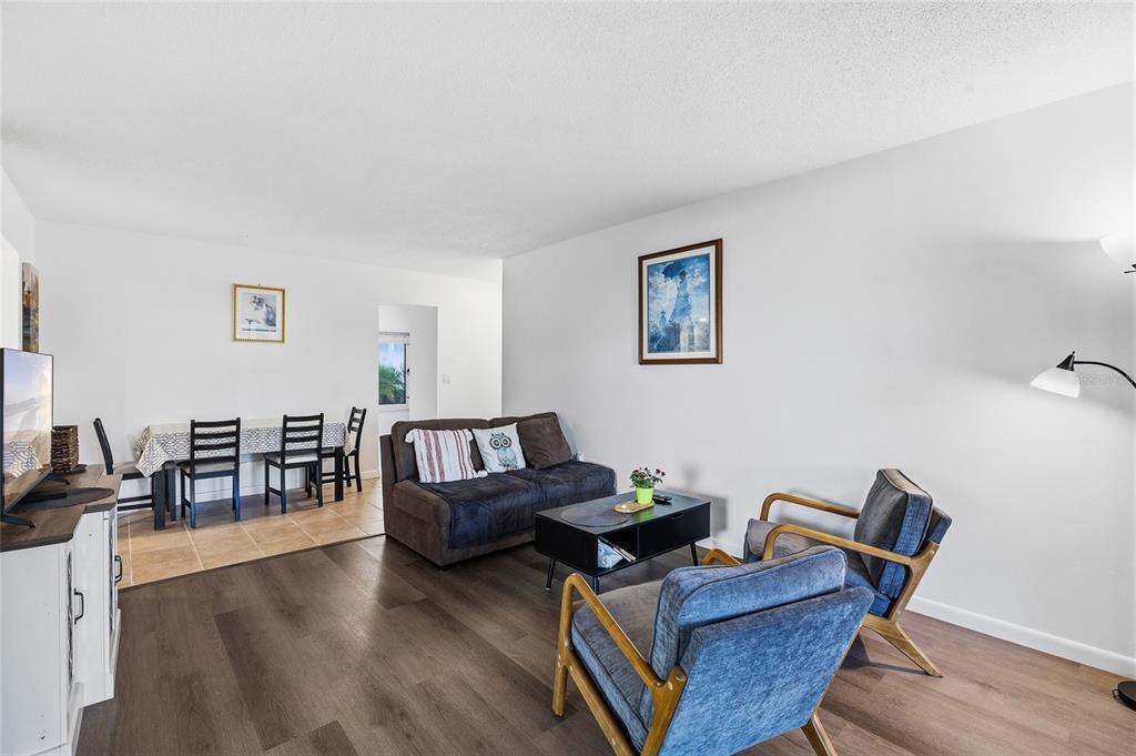 2209 Belleair Road, Unit C5 Clearwater, FL 33764 - Photo 9 of 30 a living room with furniture and a wooden floor