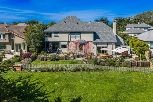 a front view of a house with a garden