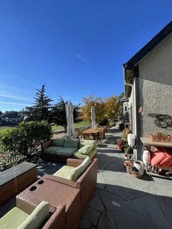 a view of a patio with couches and potted plants