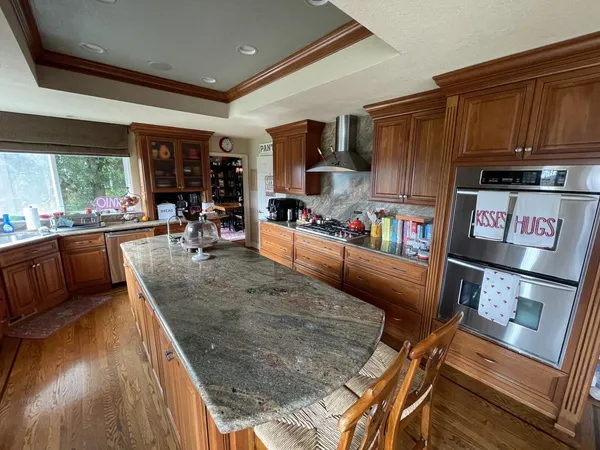 a kitchen with stainless steel appliances granite countertop sink stove top oven and cabinets