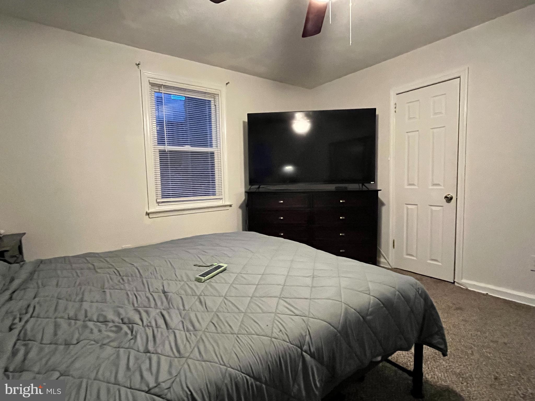 1304 Manor Road Lansdowne, PA 19050 - Photo 14 of 27 a bedroom with a bed and a flat tv screen on dresser
